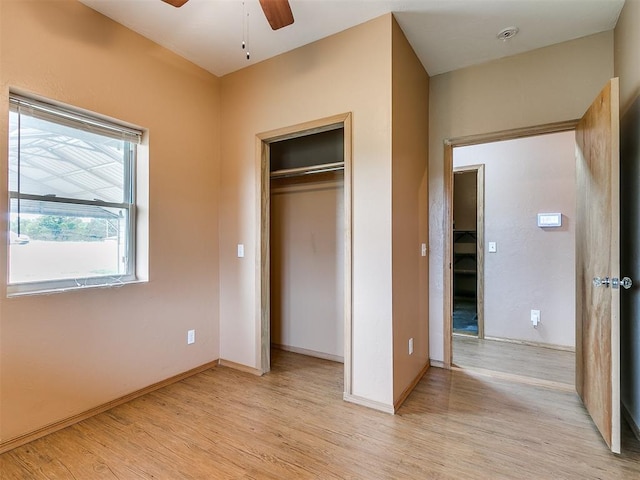 unfurnished bedroom with ceiling fan, light hardwood / wood-style floors, and a closet