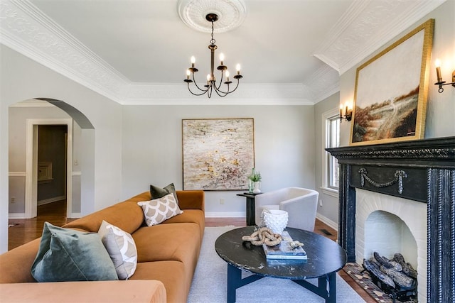 living room with hardwood / wood-style flooring, a notable chandelier, and ornamental molding