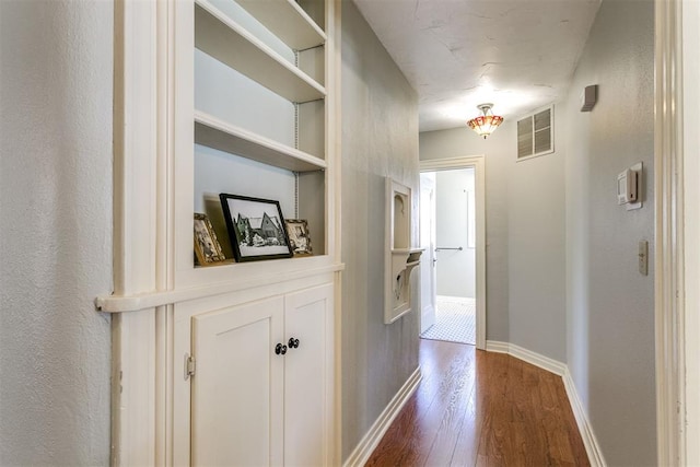 hallway with hardwood / wood-style floors