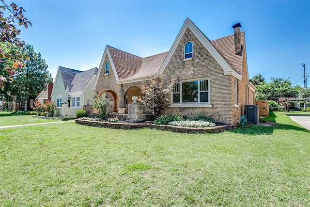 tudor-style house featuring a front yard