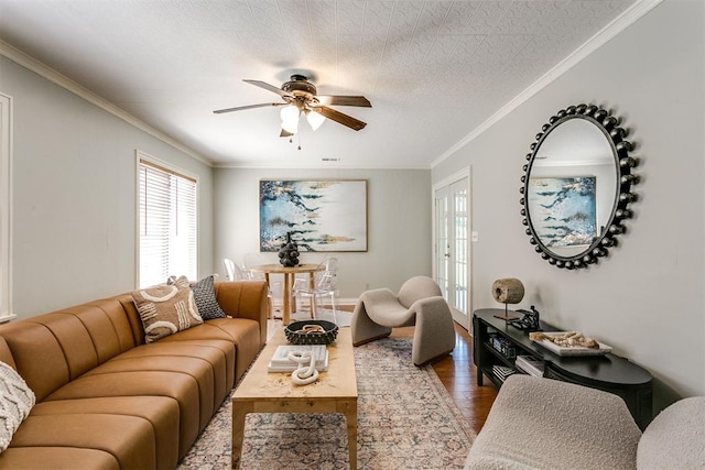 living room featuring ceiling fan, dark hardwood / wood-style flooring, crown molding, and french doors