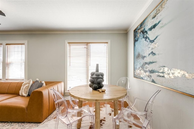 dining area featuring crown molding and plenty of natural light