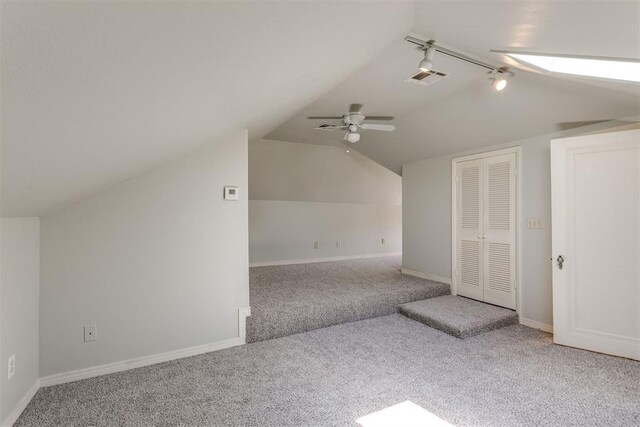 additional living space with carpet, ceiling fan, and vaulted ceiling