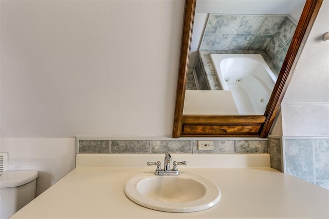 bathroom with a bathing tub, toilet, and sink