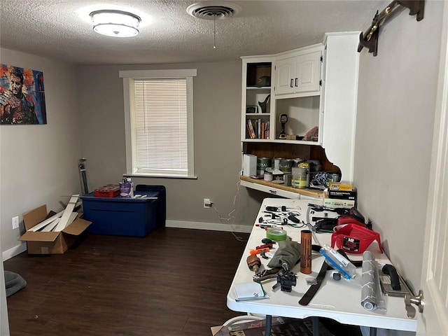 interior space featuring dark wood-type flooring and a textured ceiling