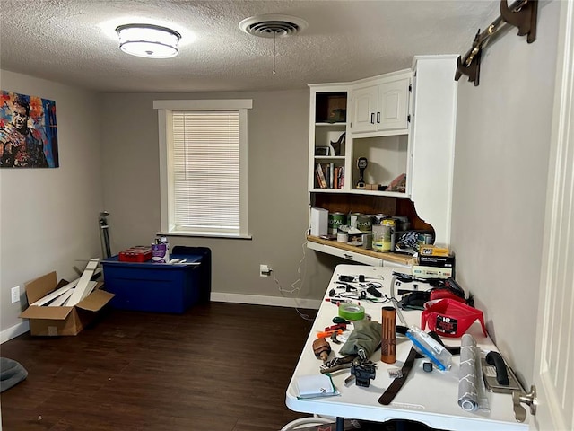 interior space featuring dark hardwood / wood-style flooring and a textured ceiling