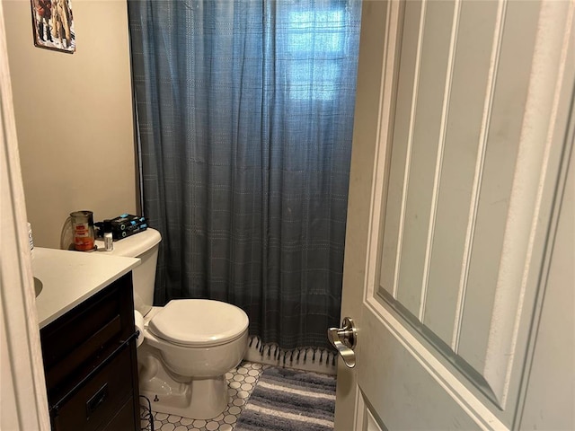 bathroom featuring tile patterned floors, vanity, and toilet