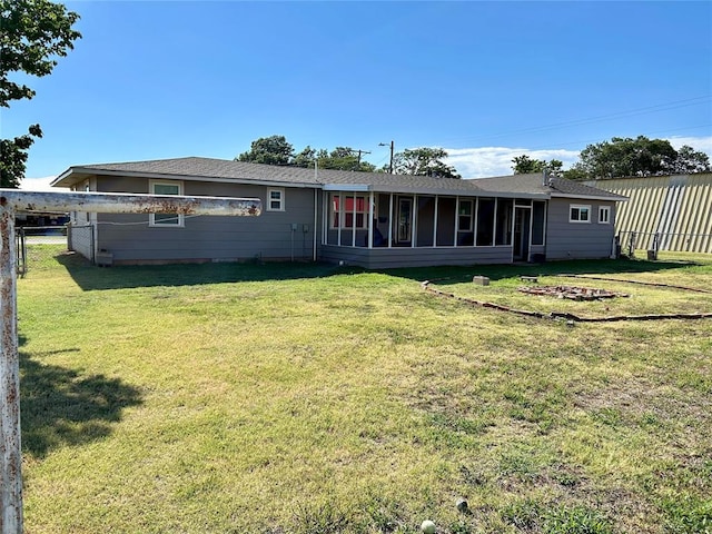 rear view of house featuring a yard