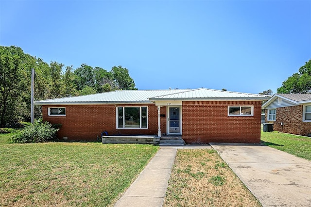 single story home featuring cooling unit and a front lawn