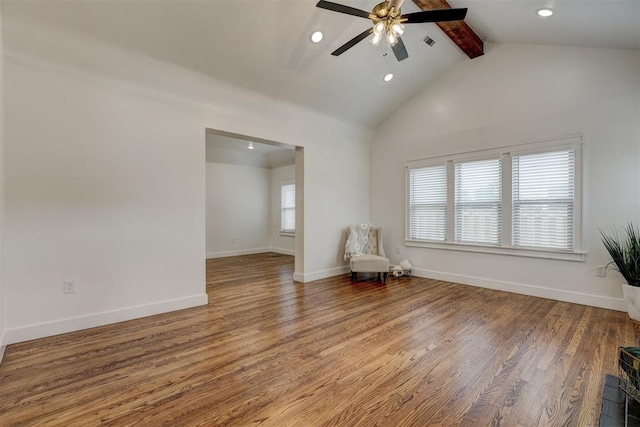 interior space featuring hardwood / wood-style floors, ceiling fan, beam ceiling, and a wealth of natural light