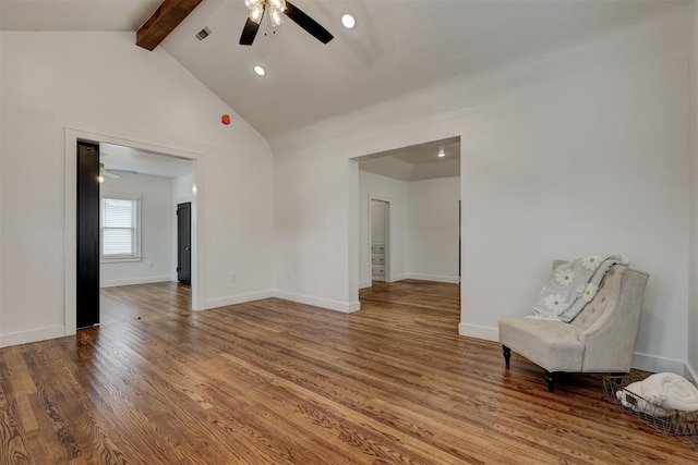 unfurnished room with beamed ceiling, ceiling fan, wood-type flooring, and high vaulted ceiling