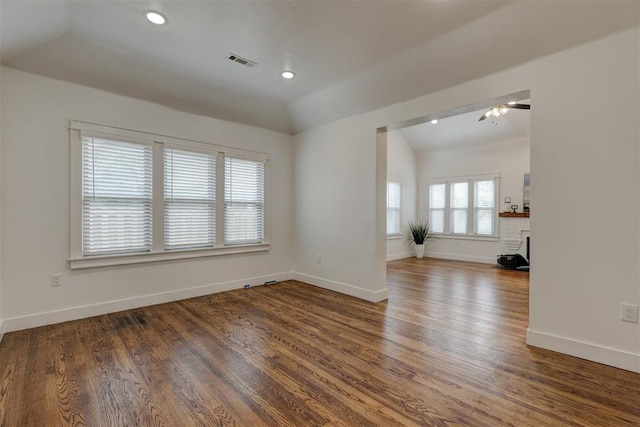 empty room featuring ceiling fan, vaulted ceiling, and hardwood / wood-style flooring