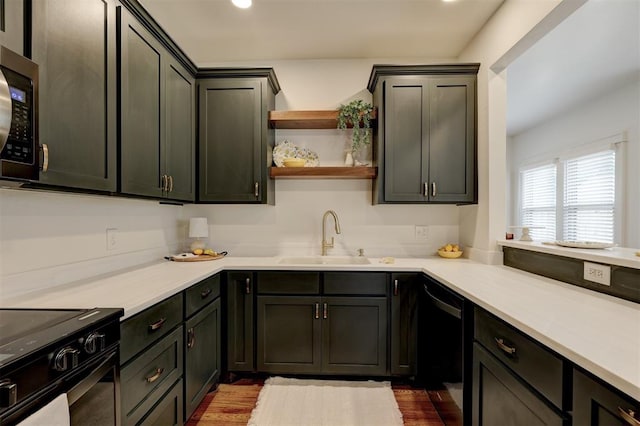 kitchen with black appliances, dark hardwood / wood-style floors, and sink