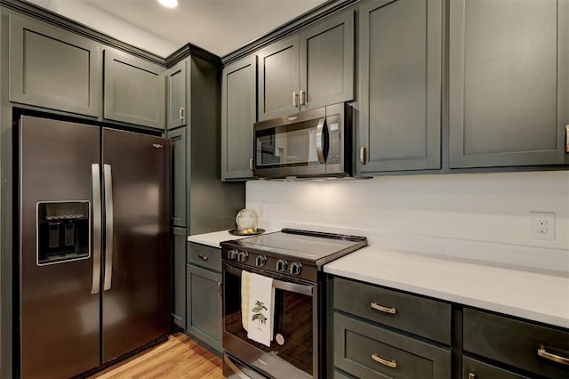 kitchen featuring light wood-type flooring and appliances with stainless steel finishes