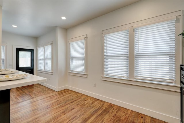 bathroom with hardwood / wood-style flooring and plenty of natural light