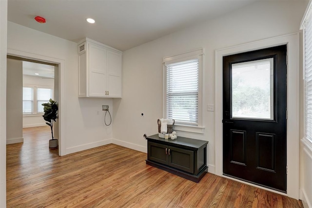 foyer with light wood-type flooring and a wealth of natural light