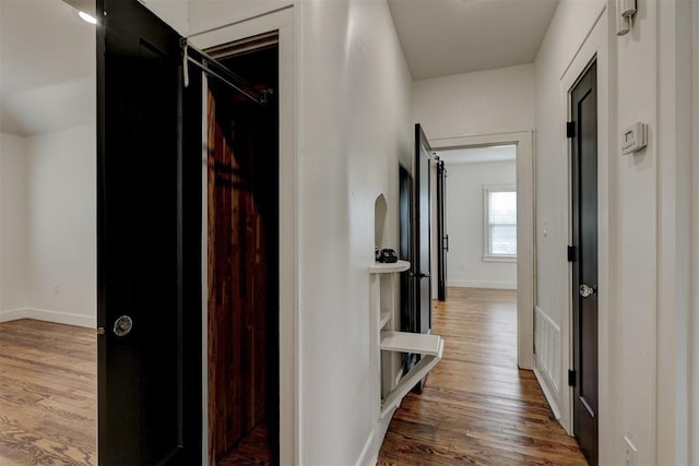 hallway with wood-type flooring