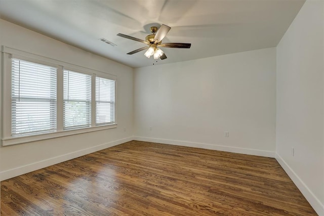 spare room featuring dark hardwood / wood-style flooring and ceiling fan