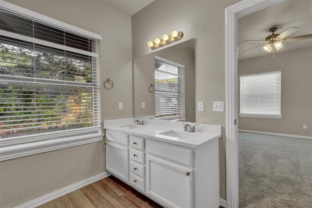 bathroom with ceiling fan, vanity, and hardwood / wood-style flooring