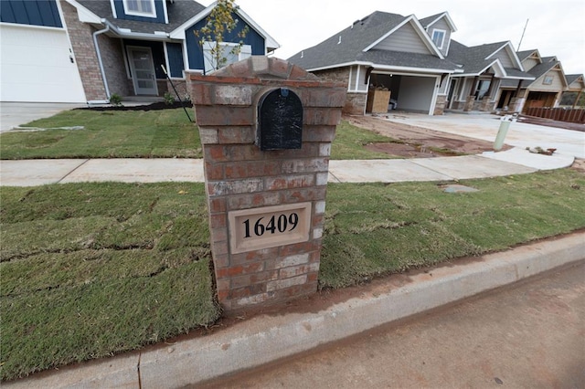 view of front of house with a garage and a front lawn