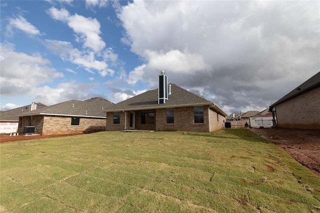 back of house with a yard and central AC