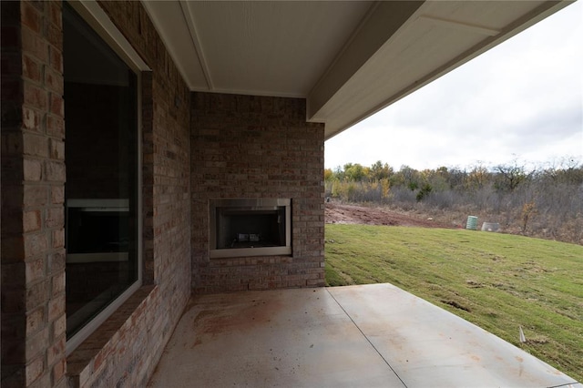 view of patio featuring an outdoor brick fireplace