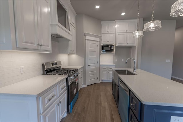 kitchen featuring dark wood-type flooring, white cabinetry, pendant lighting, and stainless steel appliances