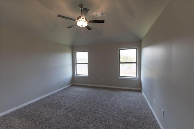 empty room with carpet, vaulted ceiling, a wealth of natural light, and ceiling fan