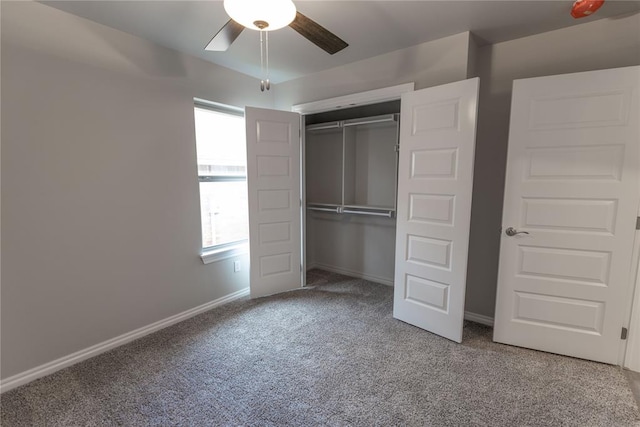 unfurnished bedroom with carpet, a closet, and ceiling fan