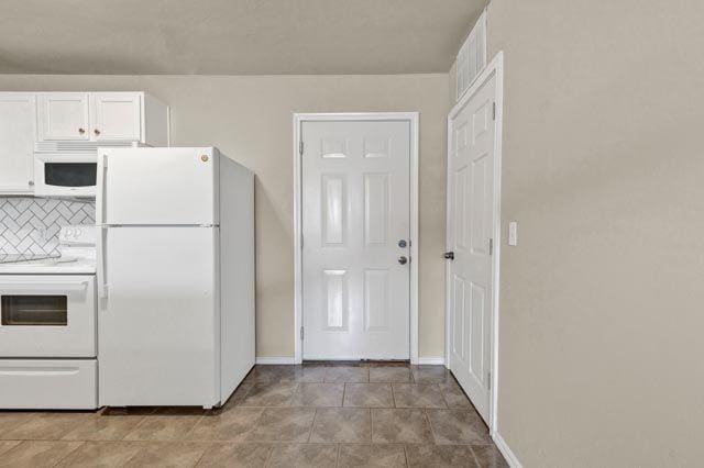 kitchen featuring white cabinets, decorative backsplash, and white appliances