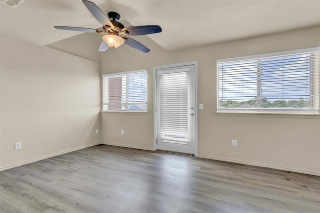 empty room with light hardwood / wood-style flooring and ceiling fan