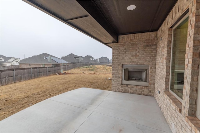 view of patio / terrace with an outdoor brick fireplace