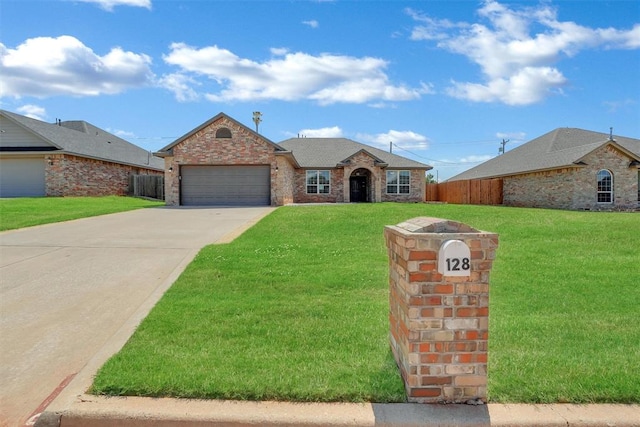 single story home featuring a garage and a front lawn