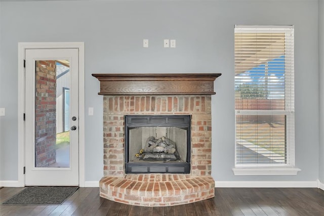 room details with a fireplace and wood-type flooring