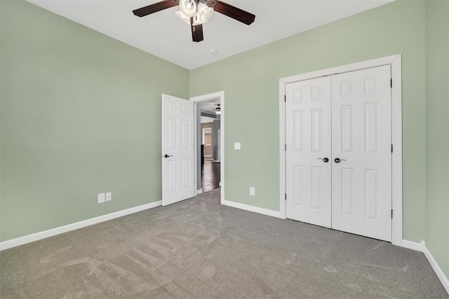 unfurnished bedroom featuring ceiling fan, a closet, and carpet