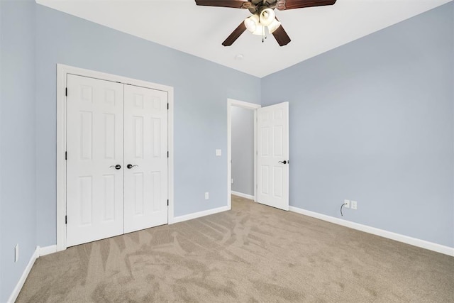 unfurnished bedroom with a closet, ceiling fan, and light colored carpet