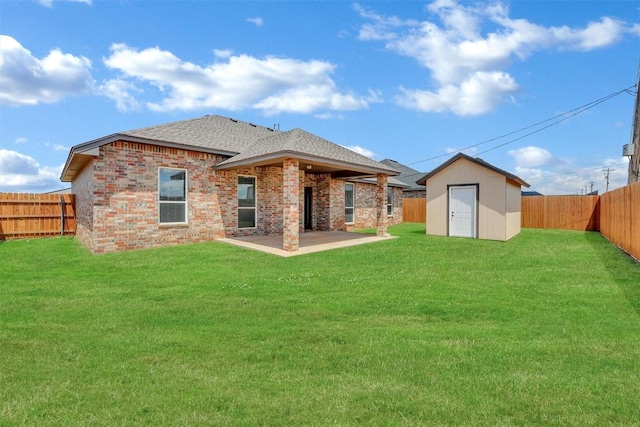 back of property featuring a patio area, a yard, and a shed