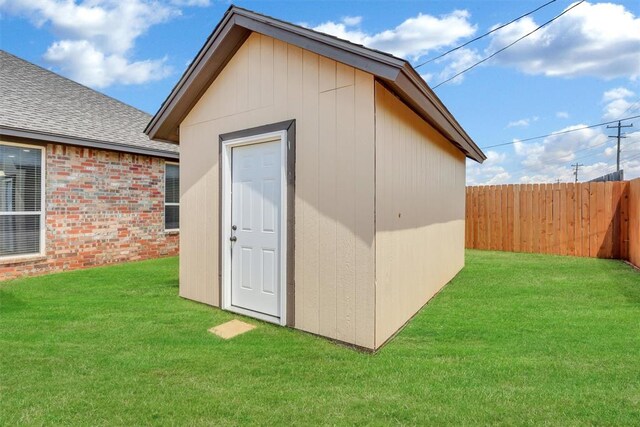 view of outbuilding with a yard