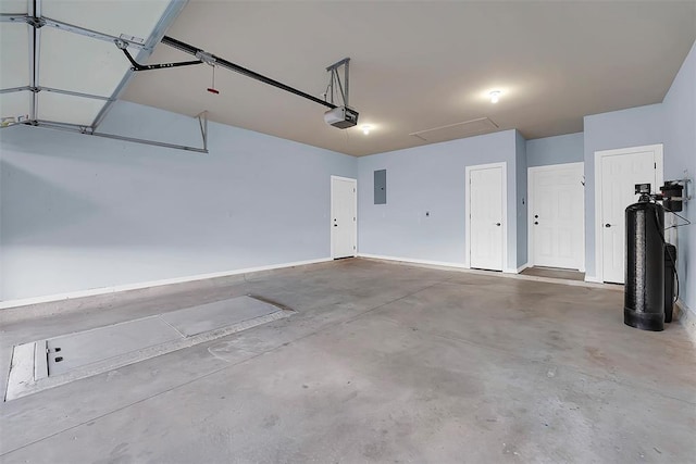 garage with electric panel and a garage door opener