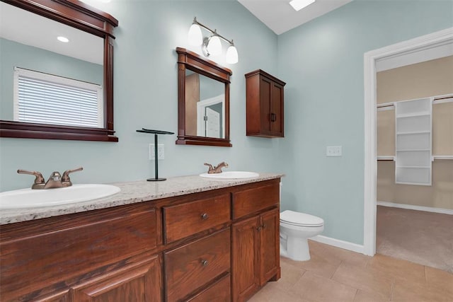 bathroom with tile patterned flooring, vanity, and toilet