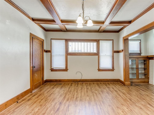 empty room with beam ceiling, light hardwood / wood-style flooring, and a notable chandelier