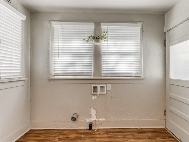 laundry area featuring washer hookup, plenty of natural light, and hardwood / wood-style floors