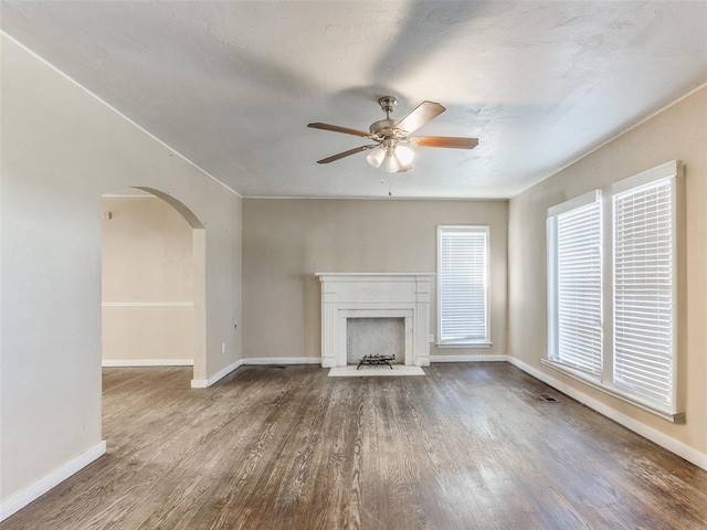 unfurnished living room featuring hardwood / wood-style flooring and ceiling fan