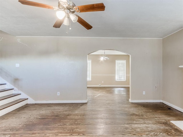 unfurnished room featuring hardwood / wood-style floors and ceiling fan with notable chandelier