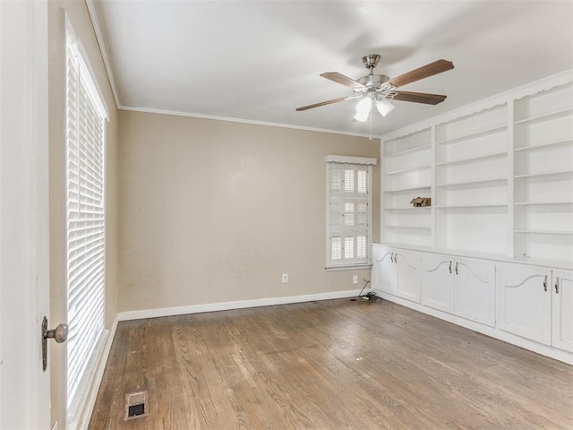 empty room with light hardwood / wood-style floors, ceiling fan, and ornamental molding