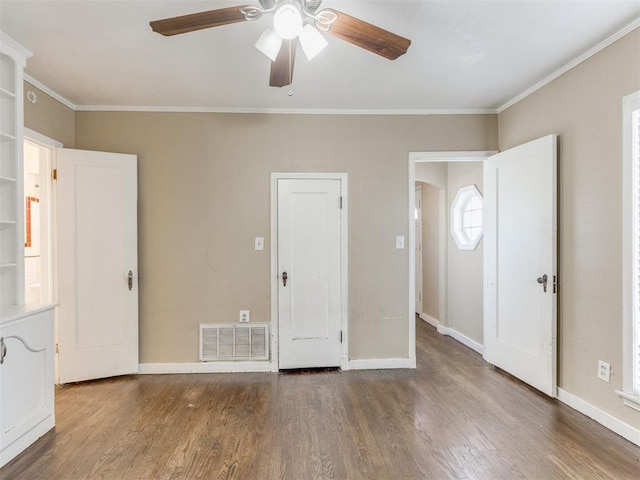 unfurnished bedroom featuring ceiling fan, dark hardwood / wood-style flooring, and ornamental molding