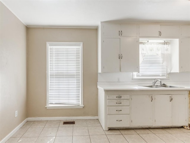 kitchen with sink and light tile patterned flooring