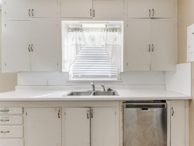 kitchen with white cabinets, dishwasher, and sink