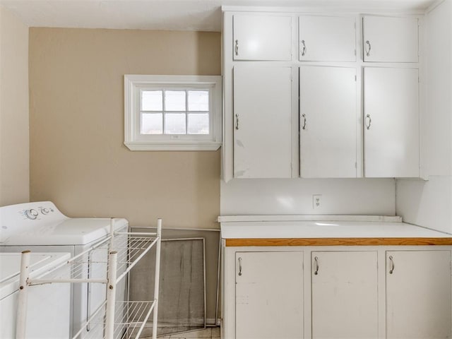 laundry area featuring cabinets and washer / dryer