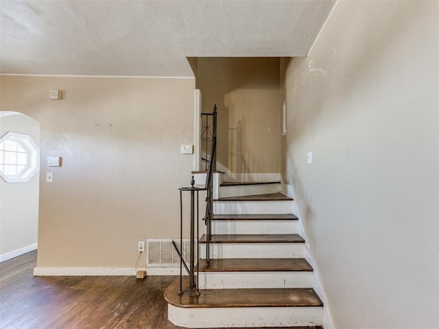 staircase featuring hardwood / wood-style floors